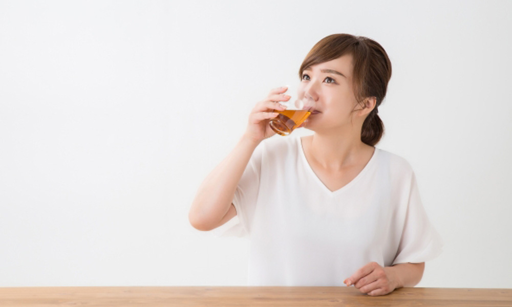 美味しそうにお茶を飲んでいる女性のイメージ